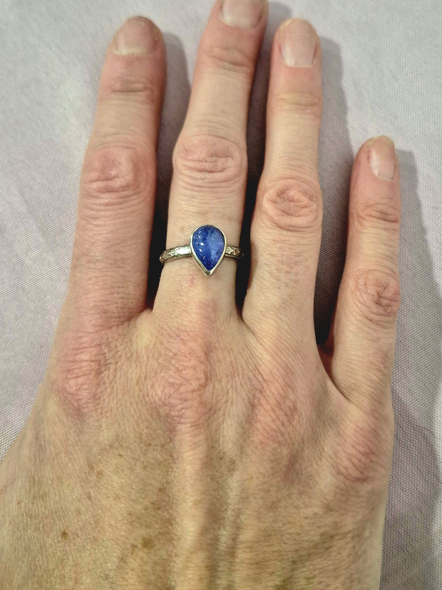 Sterling silver tanzanite ring with floral band